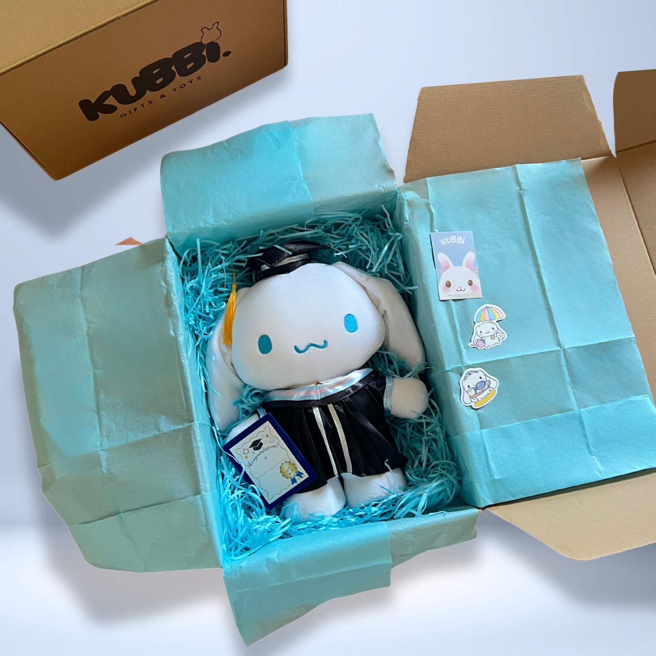 Cinnamoroll graduation gift wrapped in blue tissue paper in a decorative box and KUBI branding. Added extra stickers inside the box