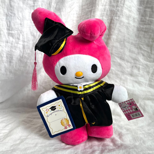 Front view of graduation MyMelody plush with cap and gown. On white/grey backgorund